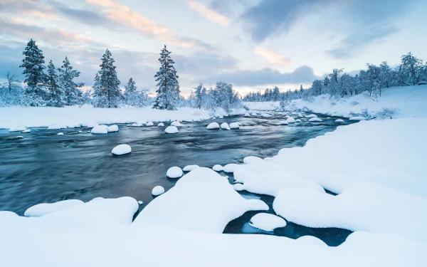 8K Ultra HD winter scene of a snowy river winding through a serene, snow-covered forest landscape under a soft, pastel sky.