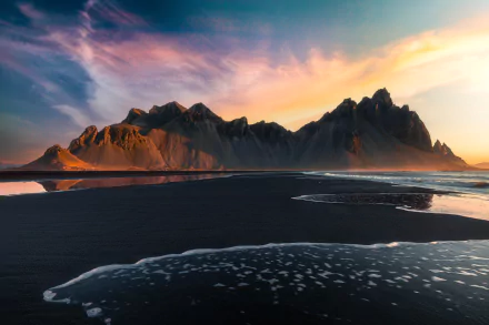 Sunset over Vestrahorn mountain on a black sand beach in Iceland, captured in stunning 8K Ultra HD resolution.