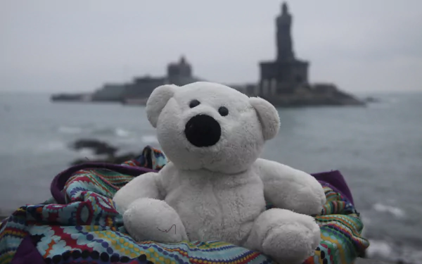 A close-up of a fluffy stuffed animal set on a wooden desktop, offering a cozy and playful HD wallpaper for a computer background.