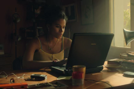 HD desktop wallpaper featuring a scene with a focused individual working on a laptop in a warmly lit room, evoking the atmosphere of Black Mirror.