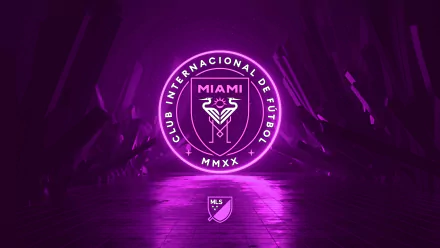 4K Ultra HD PC desktop wallpaper featuring the glowing pink Inter Miami CF logo with players' legs in the background, representing the soccer club and MLS.