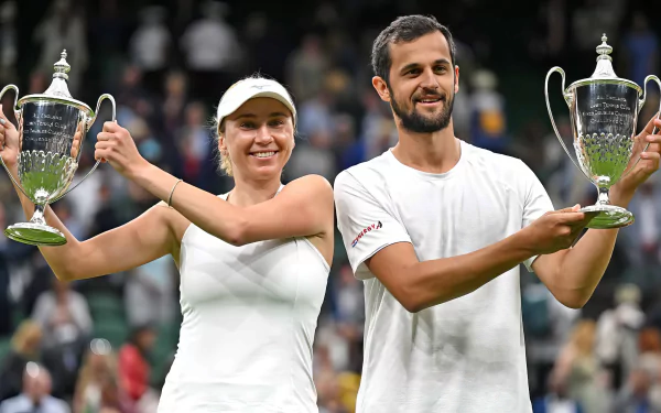 Lyudmyla Kichenok and Mate Pavic celebrate their victory at Wimbledon 2023, proudly holding their trophies amidst a lively crowd, capturing the essence of tennis excellence.