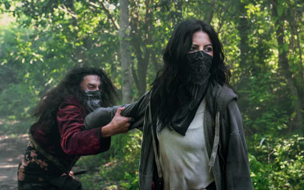 HD desktop wallpaper featuring two actors in a tense outdoor scene for the Twisted Metal series, with one character pointing a weapon from behind another.