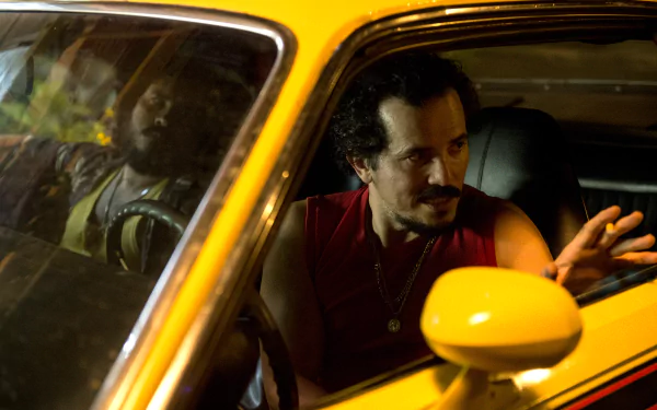 HD wallpaper featuring a man in conversation inside a yellow car for a desktop background.