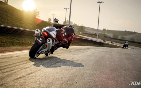 HD desktop wallpaper from the video game Ride 5, featuring a dynamic scene of a motorcyclist cornering aggressively on a racetrack at sunset.