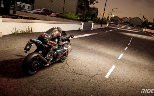 HD desktop wallpaper from the video game Ride 5 featuring a dynamic scene of a motorcycle sharply turning on a city street at night.