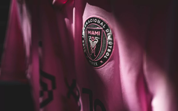 HD desktop wallpaper featuring a close-up of an Inter Miami CF pink jersey with the team's crest visible, set against a dark background.