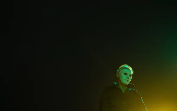 HD desktop wallpaper featuring a shadowy figure in a dark room with ominous green lighting, evoking a sense of mystery and suspense.