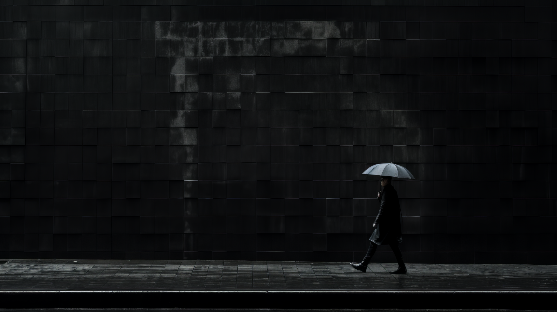 A person walks in a dark cityscape, holding a light-colored umbrella against a dramatic black backdrop, capturing a striking black aesthetic for a compelling desktop wallpaper.
