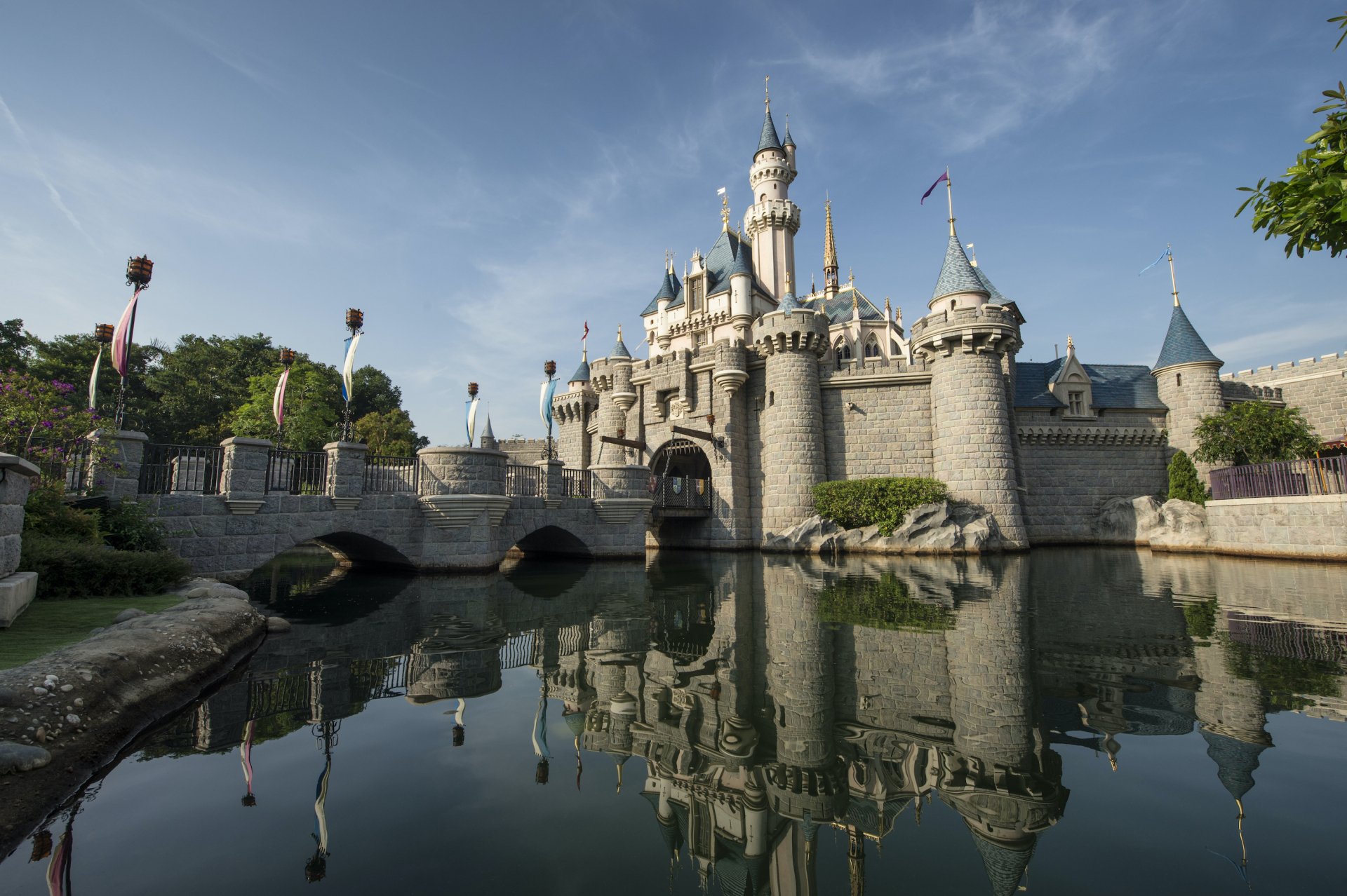 A stunning view of Cinderella Castle in Hong Kong, showcasing its majestic towers and surrounding water, reflecting the enchanting charm of Walt Disney World.