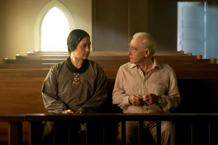 A scene from Killers of the Flower Moon featuring two characters sitting in a church, captured in HD, with warm lighting and a contemplative atmosphere.
