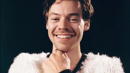 HD desktop wallpaper featuring a smiling person with a white fluffy outfit on a dark background.