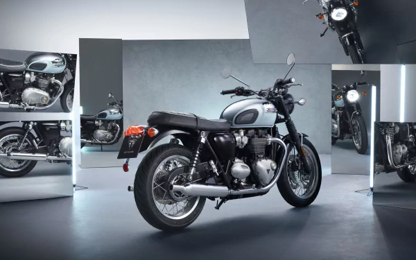 HD desktop wallpaper featuring a Triumph Bonneville T120R Chrome Edition motorcycle showcased in a stylish studio environment with reflections of the bike on surrounding surfaces.