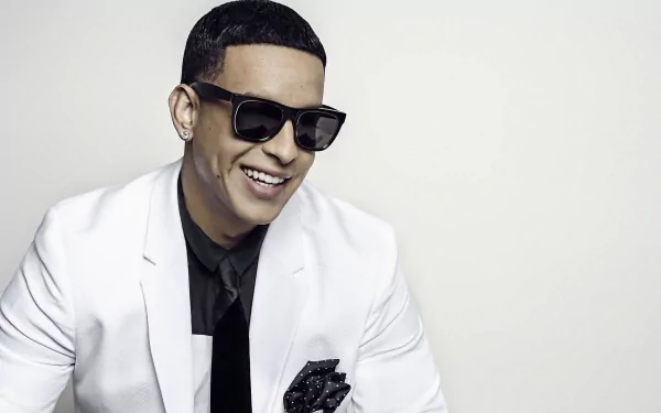 HD desktop wallpaper featuring Daddy Yankee in a white suit and sunglasses, smiling against a neutral background.