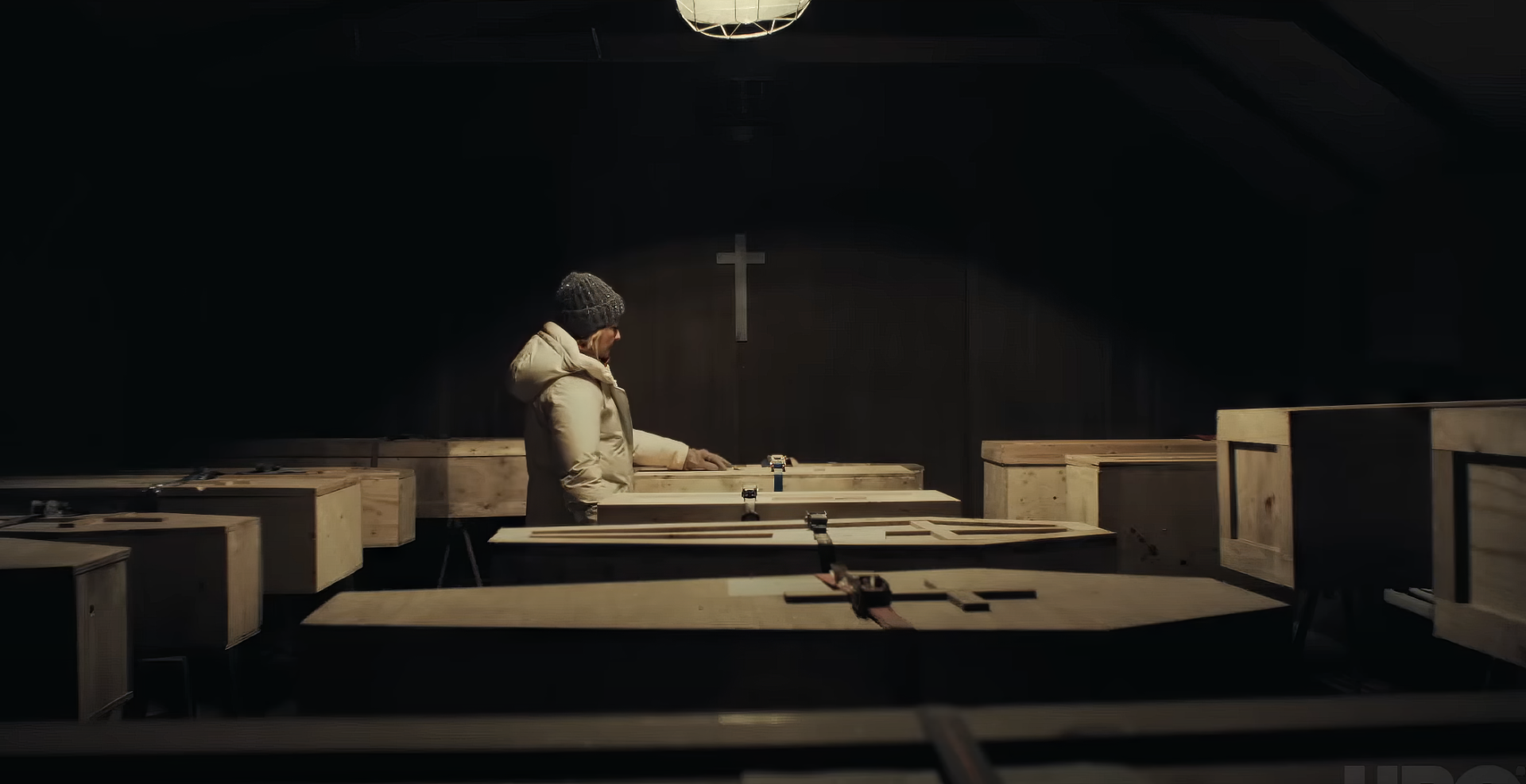 HD wallpaper of a scene from the TV show True Detective featuring a character in contemplation in a dimly lit church setup.