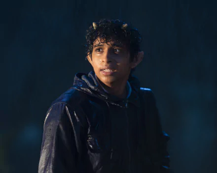 Young actor portraying a character from the TV show Percy Jackson and the Olympians in the rain, featured in a high-definition desktop wallpaper and background.
