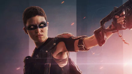 HD desktop wallpaper of a Rebel Moon character aiming a gun, amidst swirling dust and a glowing backdrop.