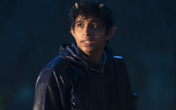 Young actor portraying a character from the TV show Percy Jackson and the Olympians in the rain, featured in a high-definition desktop wallpaper and background.