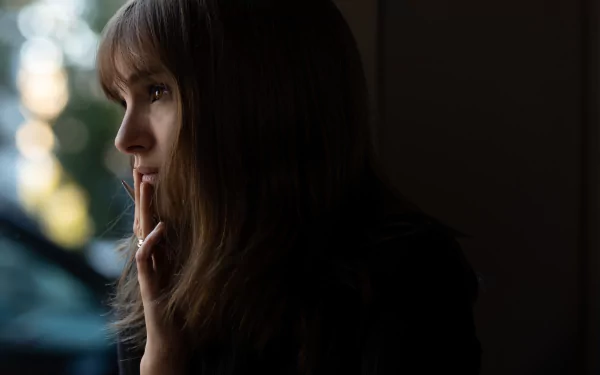 Mysterious woman in silhouette looking thoughtful in a May-December movie theme HD wallpaper background.