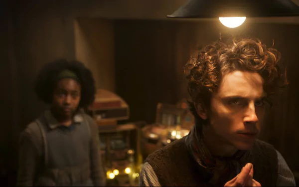 HD desktop wallpaper featuring a scene from the movie 'Wonka' with a thoughtful character in the foreground.