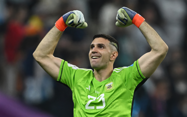 Argentinian national team soccer goalkeeper Emiliano Martinez celebrating during a match, in vibrant HD wallpaper perfect for desktop background.