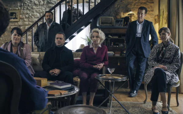 HD wallpaper featuring a scene from the TV show Monsieur Spade with characters seated in a vintage-styled living room, providing a moody and intriguing desktop background.