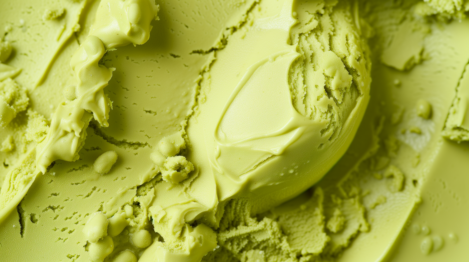 Close-up of vibrant green gelato with a creamy texture, showcased as an HD desktop wallpaper and background, inviting a fresh and delightful aesthetic.