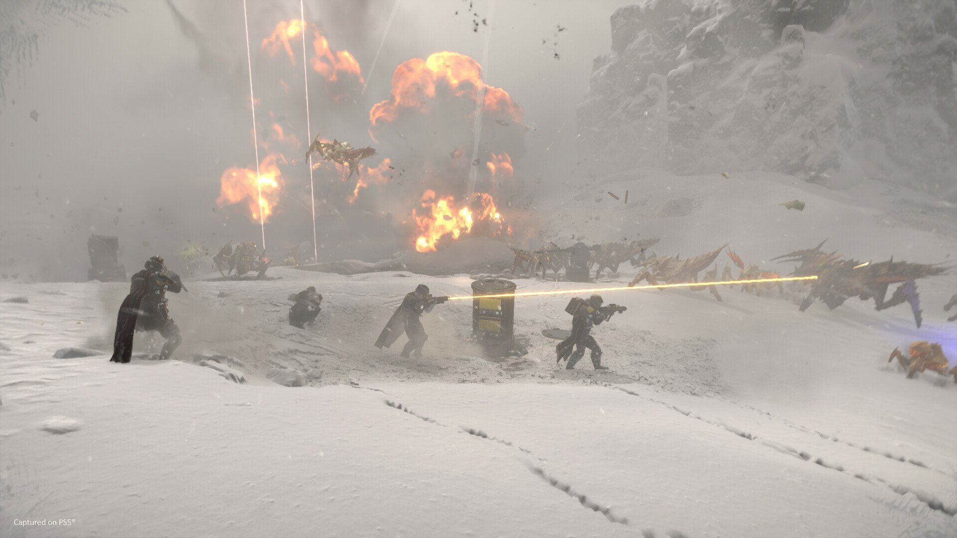 HD wallpaper of Helldivers 2 featuring soldiers in combat on a snowy battlefield with explosions in the background.