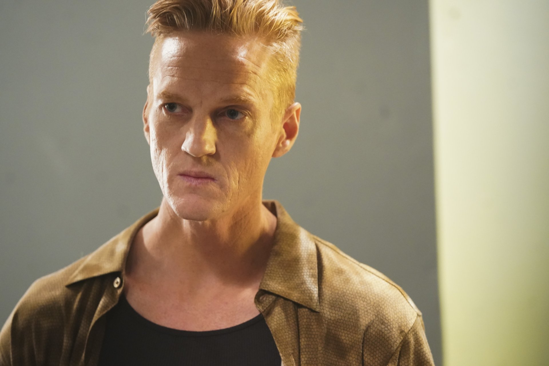 HD desktop wallpaper from 'The Rookie' TV show featuring a serious-looking character in a brown jacket.