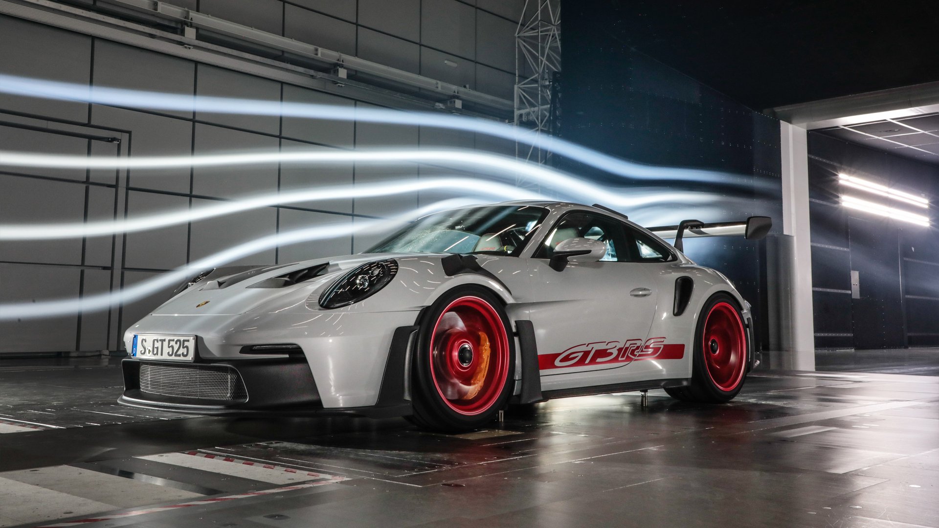 A stunning HD wallpaper featuring a Porsche 911 GT3 RS, showcasing its sleek design and vibrant red accents against a dramatic backdrop.