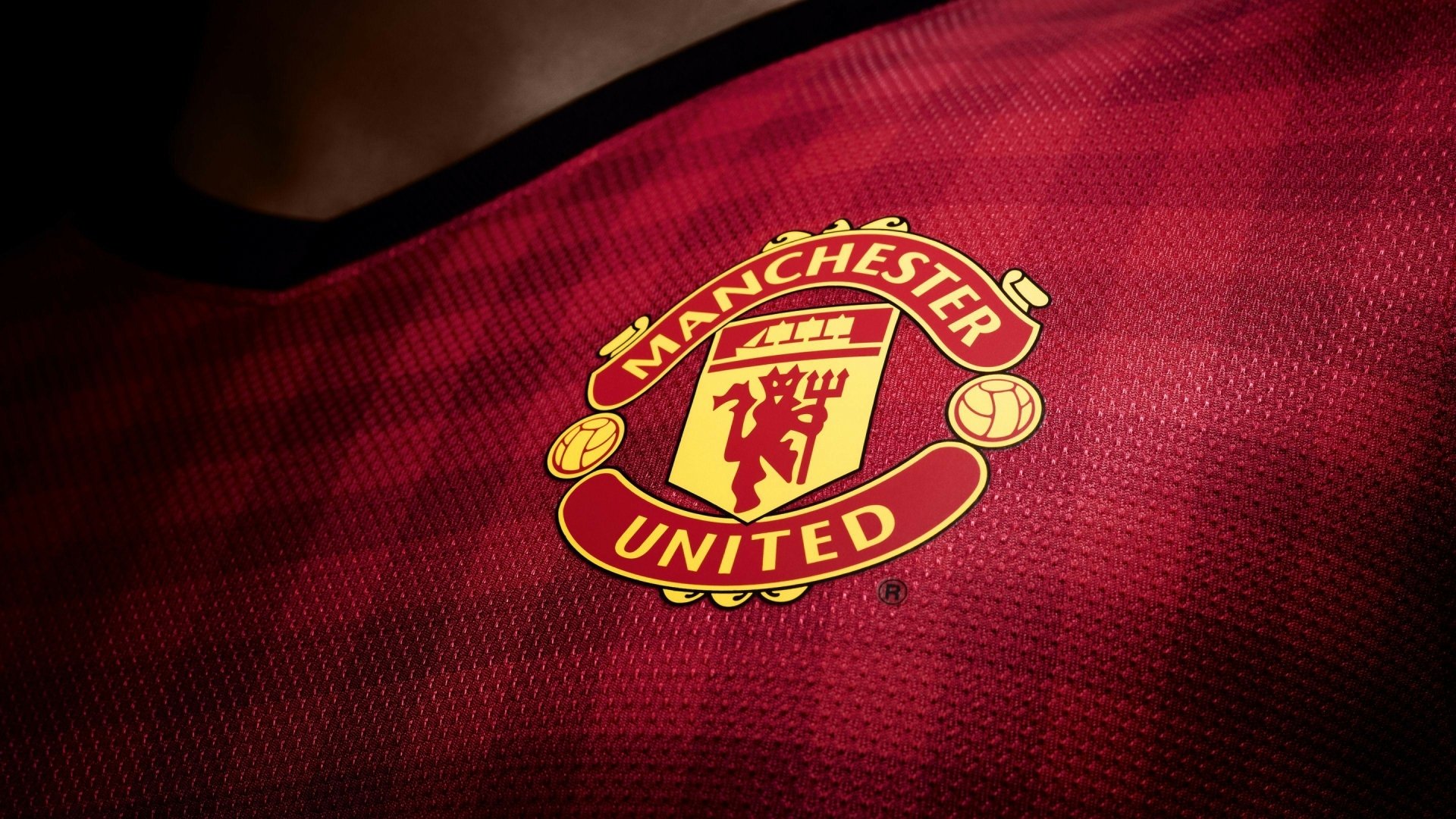 HD Manchester United F.C. crest on a red soccer jersey, capturing the essence of the Premier League club as desktop wallpaper.