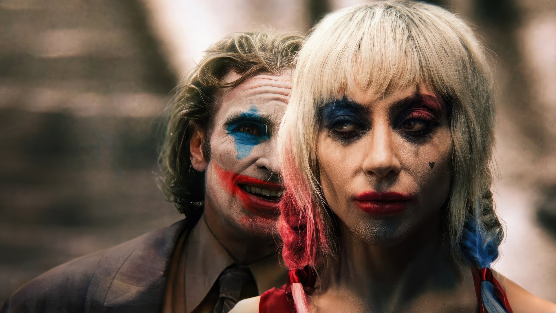 HD wallpaper featuring two characters with clown makeup, reminiscent of the Joker style, standing close to each other with intense expressions.