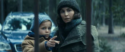HD wallpaper featuring two characters from the TV Show Constellation, with a woman pointing into the distance as a child looks on, set in a wintery forest backdrop.