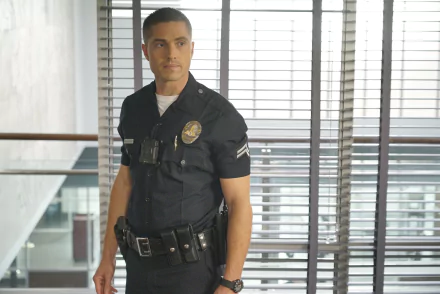 HD desktop wallpaper from The Rookie TV show featuring a uniformed police officer standing confidently indoors.