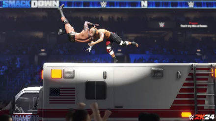 HD desktop wallpaper of WWE 2K24 video game featuring a wrestler performing a high-flying move over an ambulance in an arena.