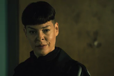 A dramatic scene from The Walking Dead: The Ones Who Live, featuring a character with a striking look, set against a blurred background. This HD wallpaper captures the show's intense atmosphere.