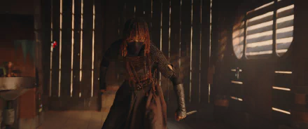 HD wallpaper featuring a scene from the TV show The Acolyte (2024) with a mysterious character in a dimly lit setting reminiscent of a starship or other futuristic interior.