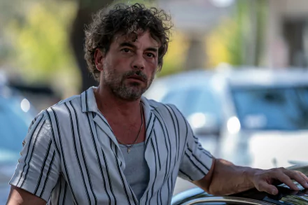 HD wallpaper featuring a character from the TV show Parish (2024) with a focused gaze, set against an urban backdrop.