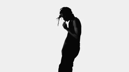 HD PC desktop wallpaper featuring a black silhouette of Playboi Carti against a plain white background, highlighting his distinctive pose and style in music.