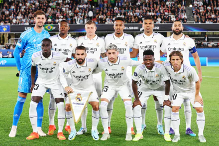 HD wallpaper featuring Real Madrid C.F. soccer team posing together in their white home kits before a match.