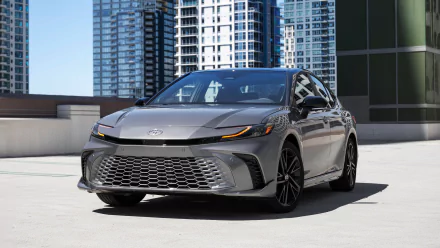 A Toyota Camry XSE parked with modern high-rise buildings in the background, used as an HD desktop wallpaper.