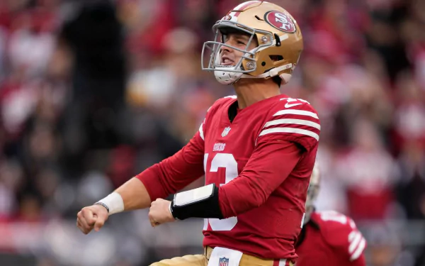 Brock Purdy celebrates a successful play in a striking moment during a San Francisco 49ers game, embodying the excitement of the NFL and the Super Bowl spirit. HD desktop wallpaper.