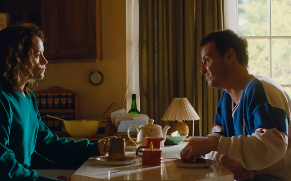 HD wallpaper featuring a scene from the movie 'All of Us Strangers' with two characters engaging in a conversation at a kitchen table.