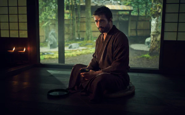 HD wallpaper of a brooding character from the 2024 TV show Shogun, seated contemplatively in a traditional Japanese room with serene garden view.