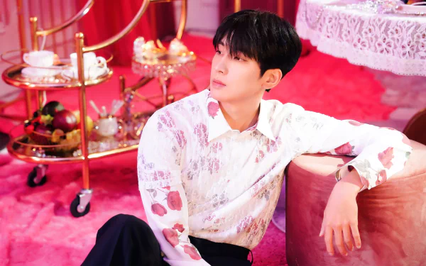 HD desktop wallpaper featuring a stylish male singer in a floral shirt posing in a lavish red room with a vintage aesthetic.