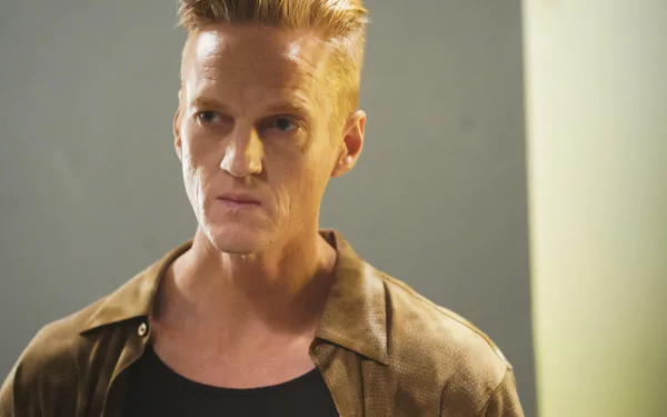 HD desktop wallpaper from 'The Rookie' TV show featuring a serious-looking character in a brown jacket.