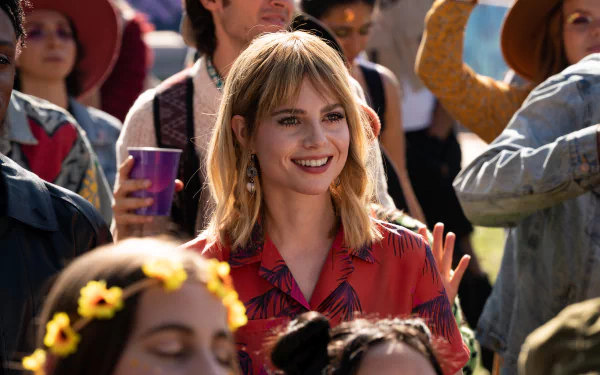 HD desktop wallpaper featuring Lucy Boynton from the movie The Greatest Hits, set in a lively outdoor scene.