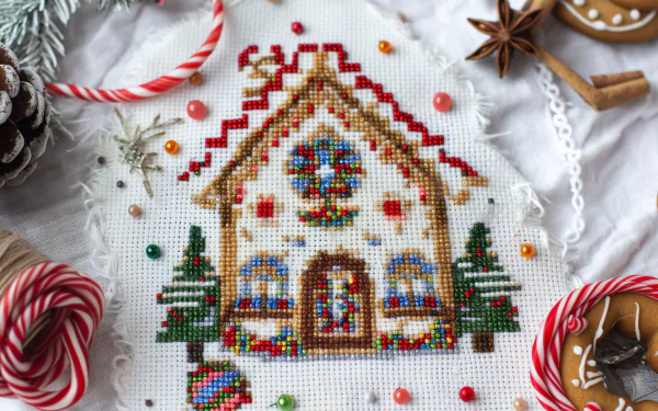 HD desktop wallpaper featuring a colorful gingerbread house with sprinkles, surrounded by festive candy and holiday decorations.