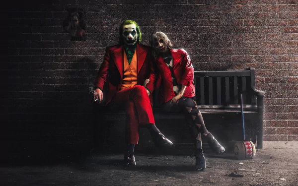HD desktop wallpaper featuring characters from the movie Joker: Folie à Deux sitting on a bench against a brick wall background.