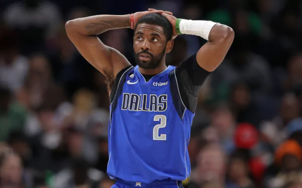A professional basketball player wearing a Dallas Mavericks jersey with the number 2, standing on the court with his hands on his head in a HD desktop wallpaper.